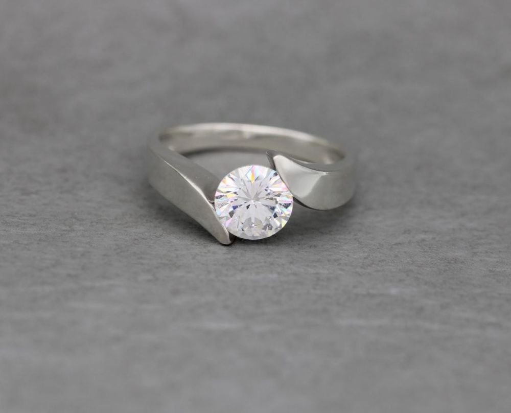 Bold sterling silver bypass style clear solitaire ring