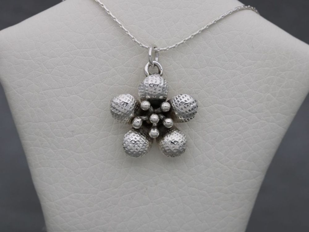 Handmade textured sterling silver flower head necklace