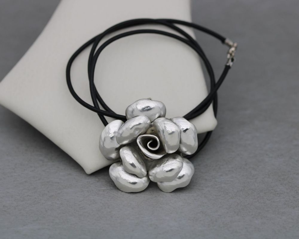 Large three-dimensional sterling silver rose pendant on a black leather thong chain