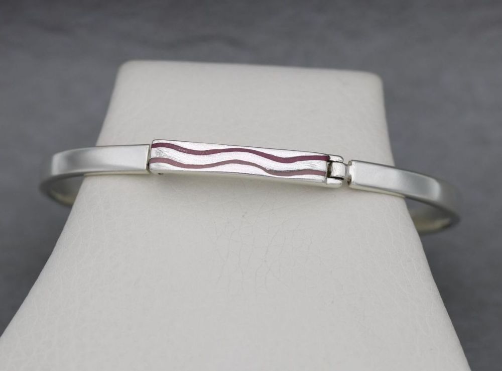 Sterling silver bangle with two pink enamel waves
