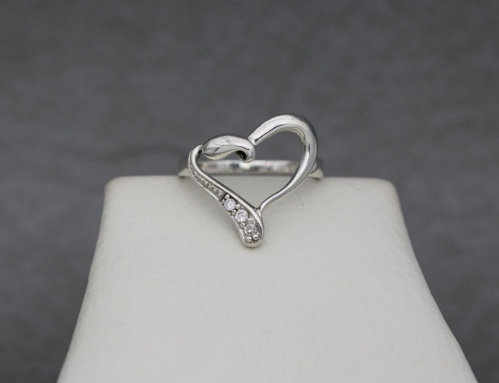 Asymmetric sterling silver heart ring with clear stone detail