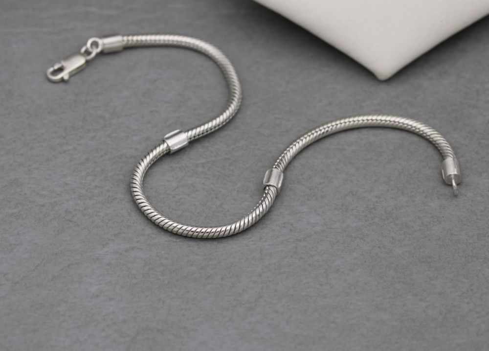 Modern sterling silver snake chain charm bracelet with fixed spacers