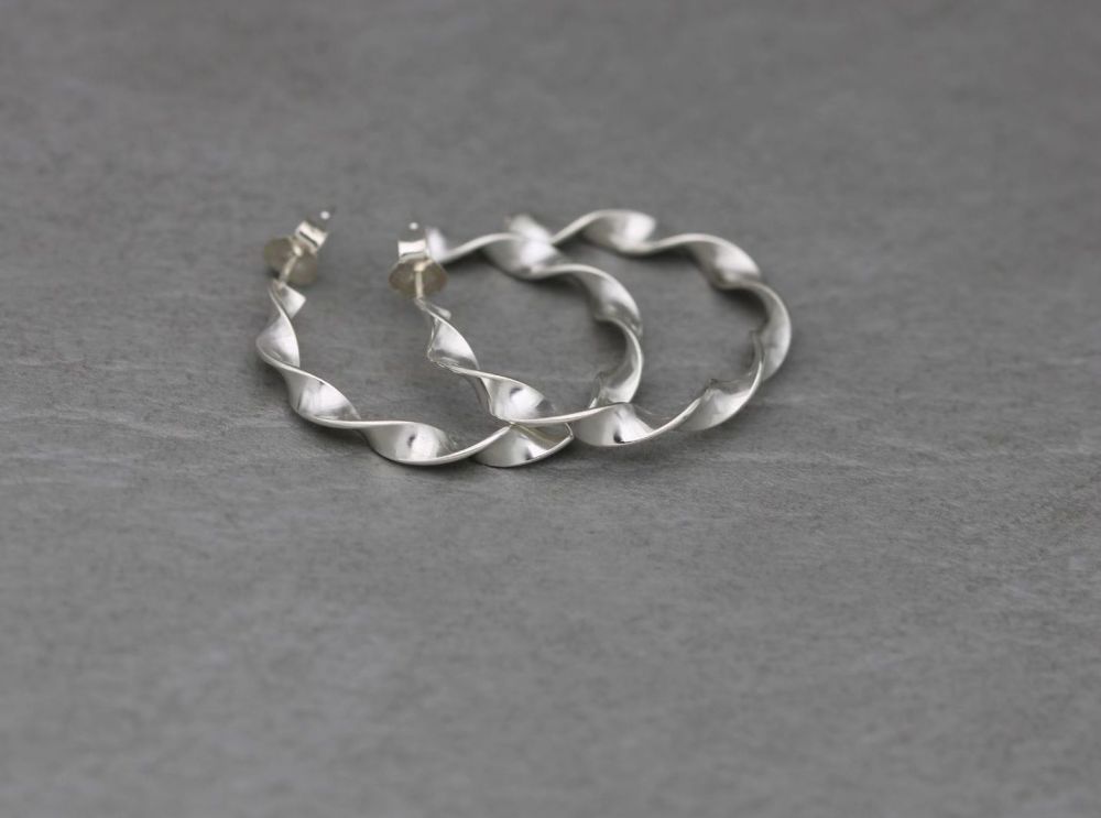 Twisted sterling silver hoop style earrings