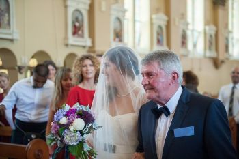 Bride and father of the bride down the aisle