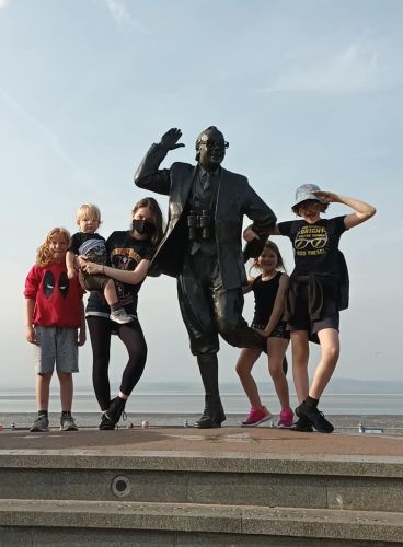 Kids posing by the Eric Morecambe statue