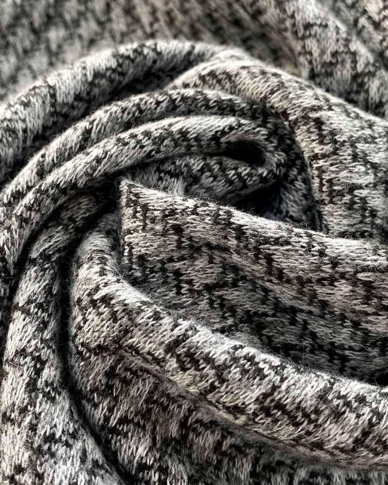 Soft shades of grey textured wool looking fabric swirled into a central loop.  Photo by Just Sew Helen