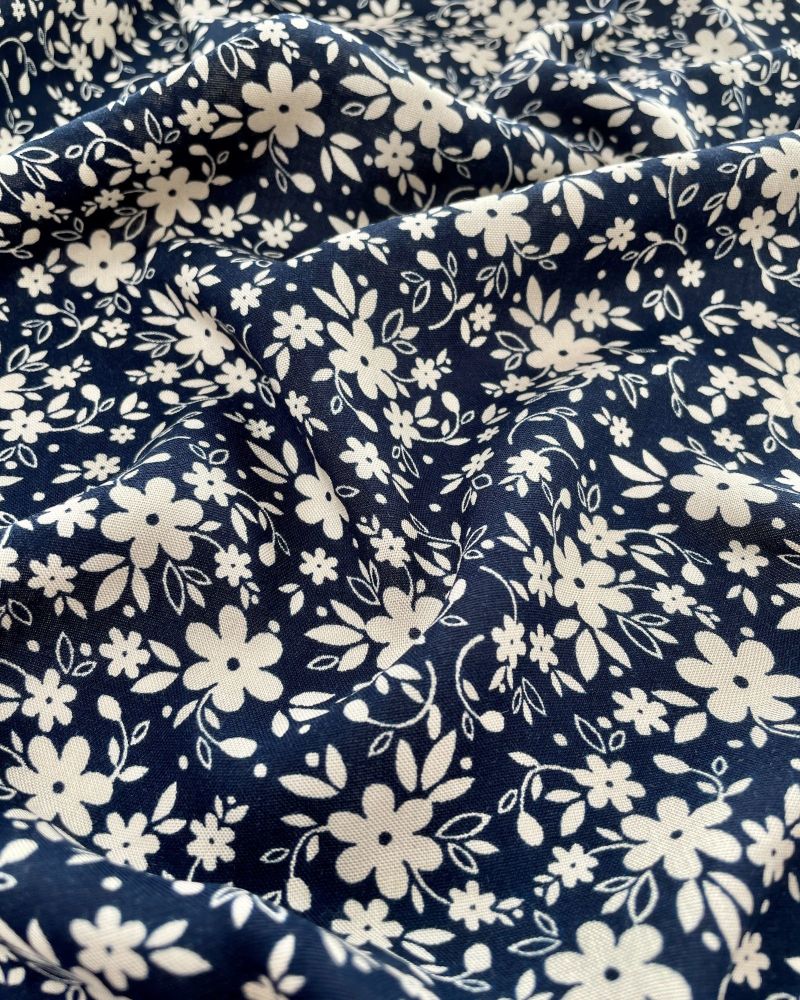 Navy blue viscose fabric with sand coloured flowers and leaves.