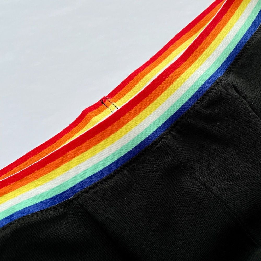 Rainbow Plush Elastic close up view sewn onto black jersey men's boxer briefs