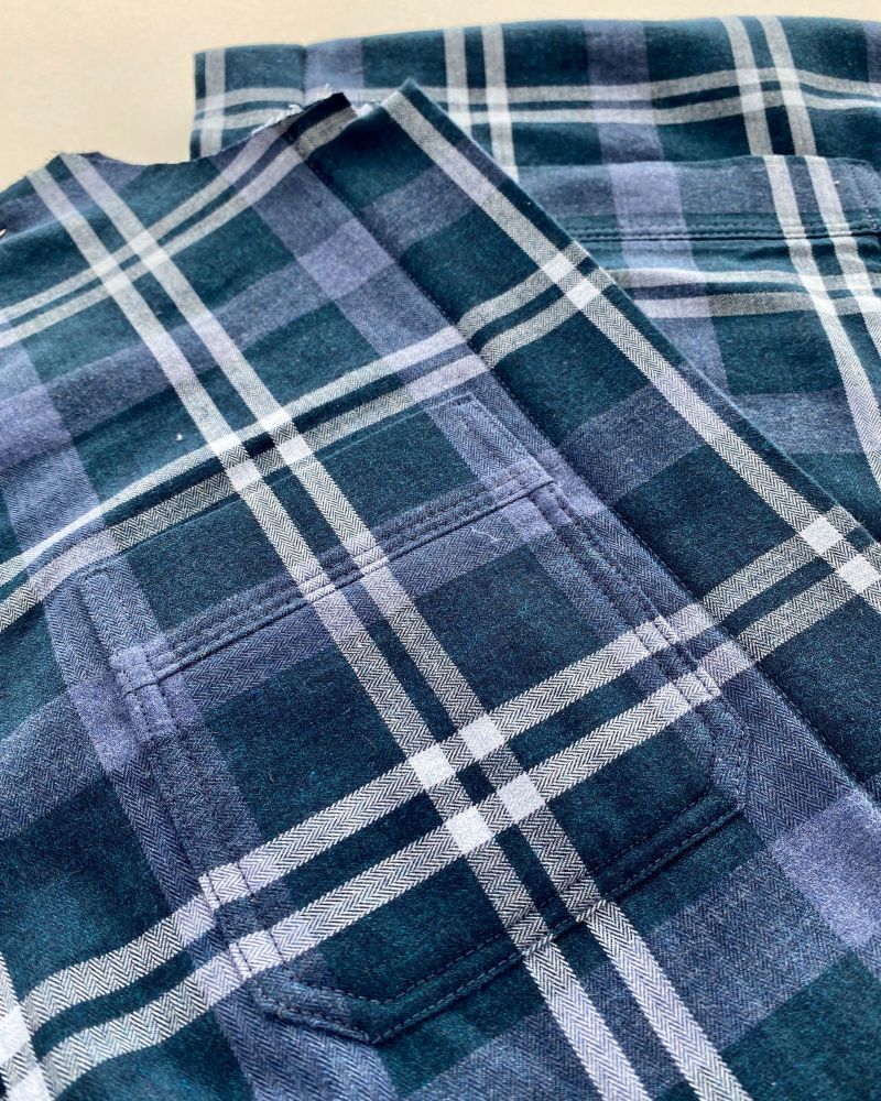 Front piece of a blue checked jacket showing the matched pattern on the pockets