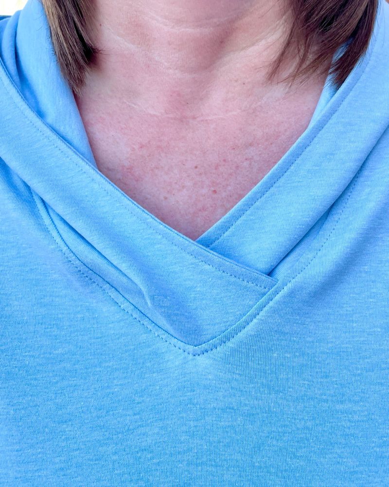 A close up photo of a lady wearing a V Neck Tunic