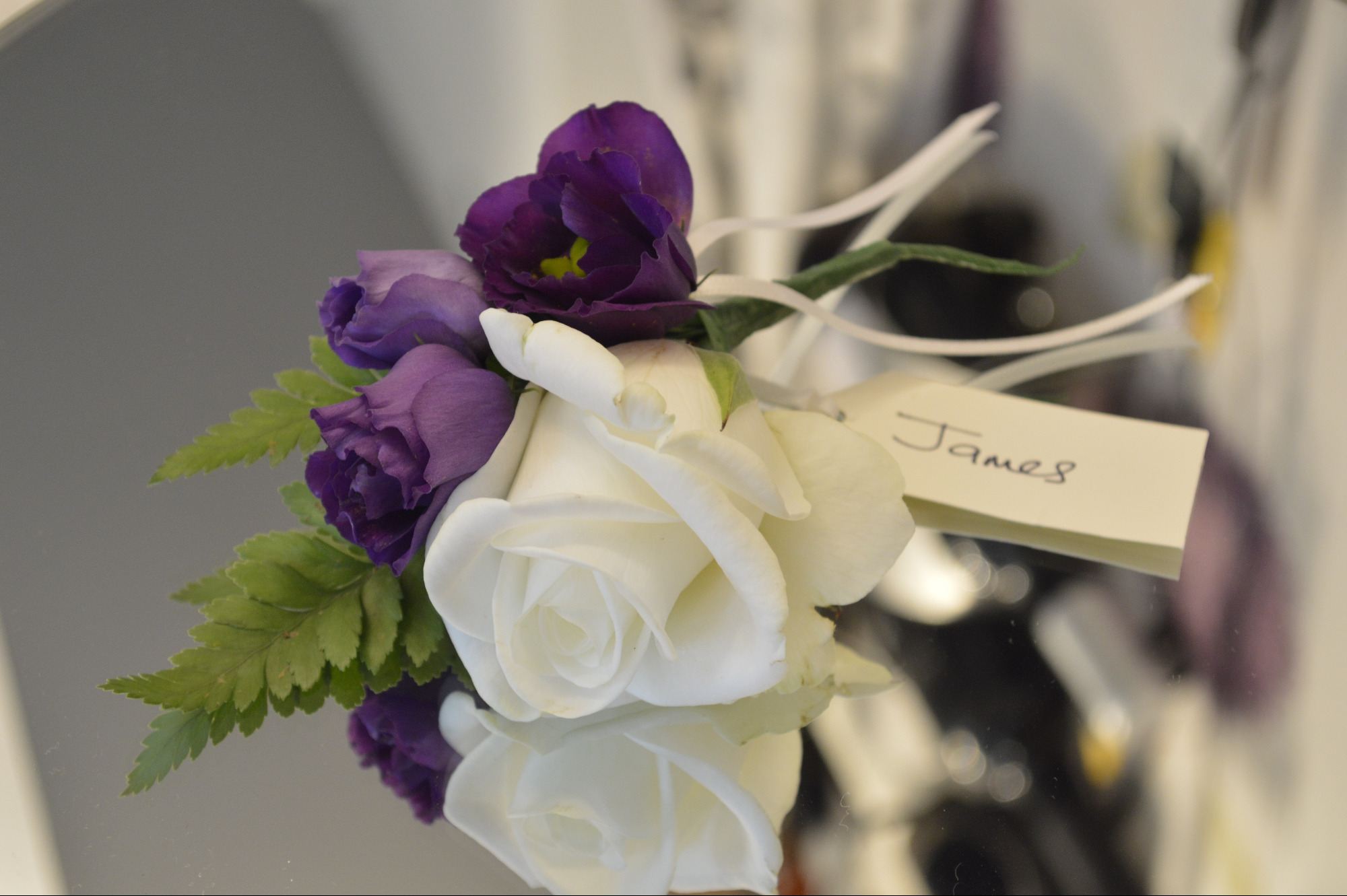 Ivory cream and purple buttonhole corsage