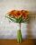 Brides bouquet of orange calla lilies with Grandmothers brooch