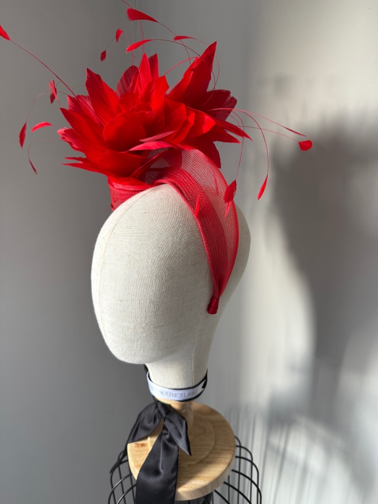 Red knotted fascinator with feathers