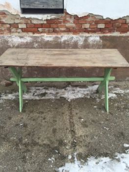 wood table with green criss cross legs 