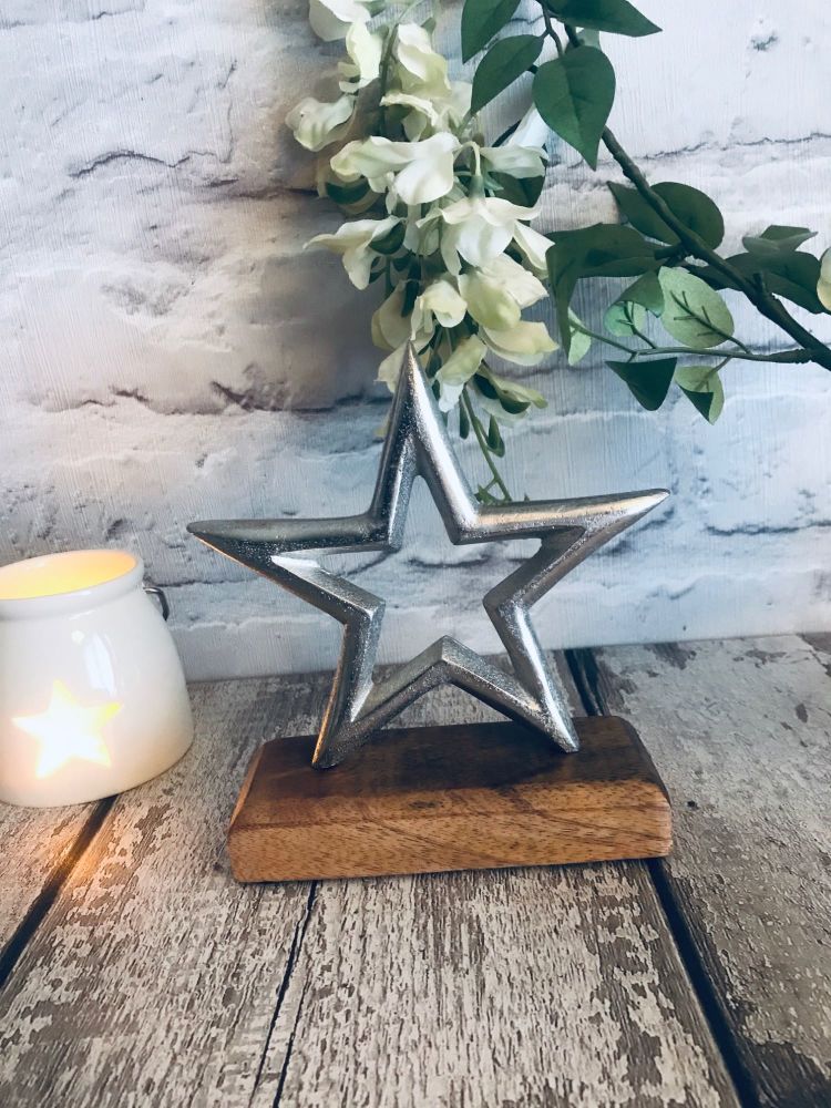 Aluminium Star on wooden block