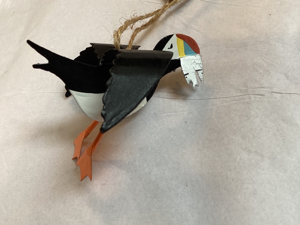 Flying Puffin with its catch