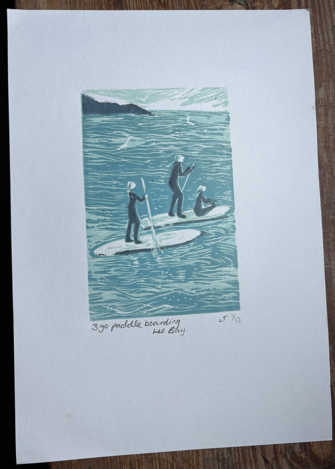 3 go paddle boarding Lee bay