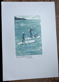 3 go paddle boarding Lee bay