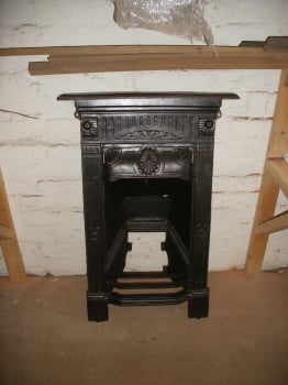 Reclaimed Victorian cast iron fireplace.