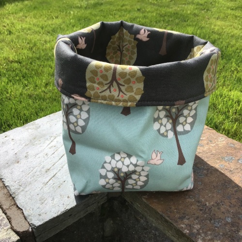 Small tree and bird themed reversible storage bin