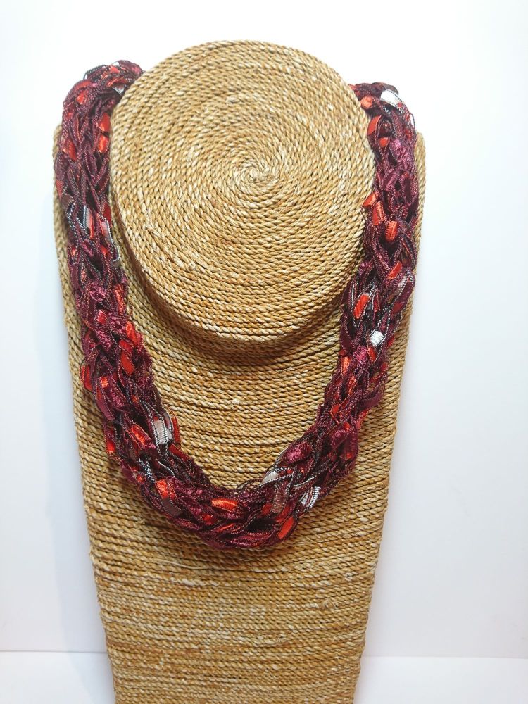 Finger knitted necklace in red, maroon and white