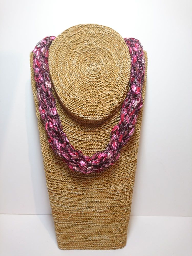 Finger knitted necklace in shades of pink