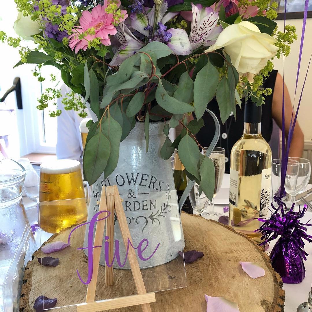 Clear acrylic table number with purpel vinyl lettering