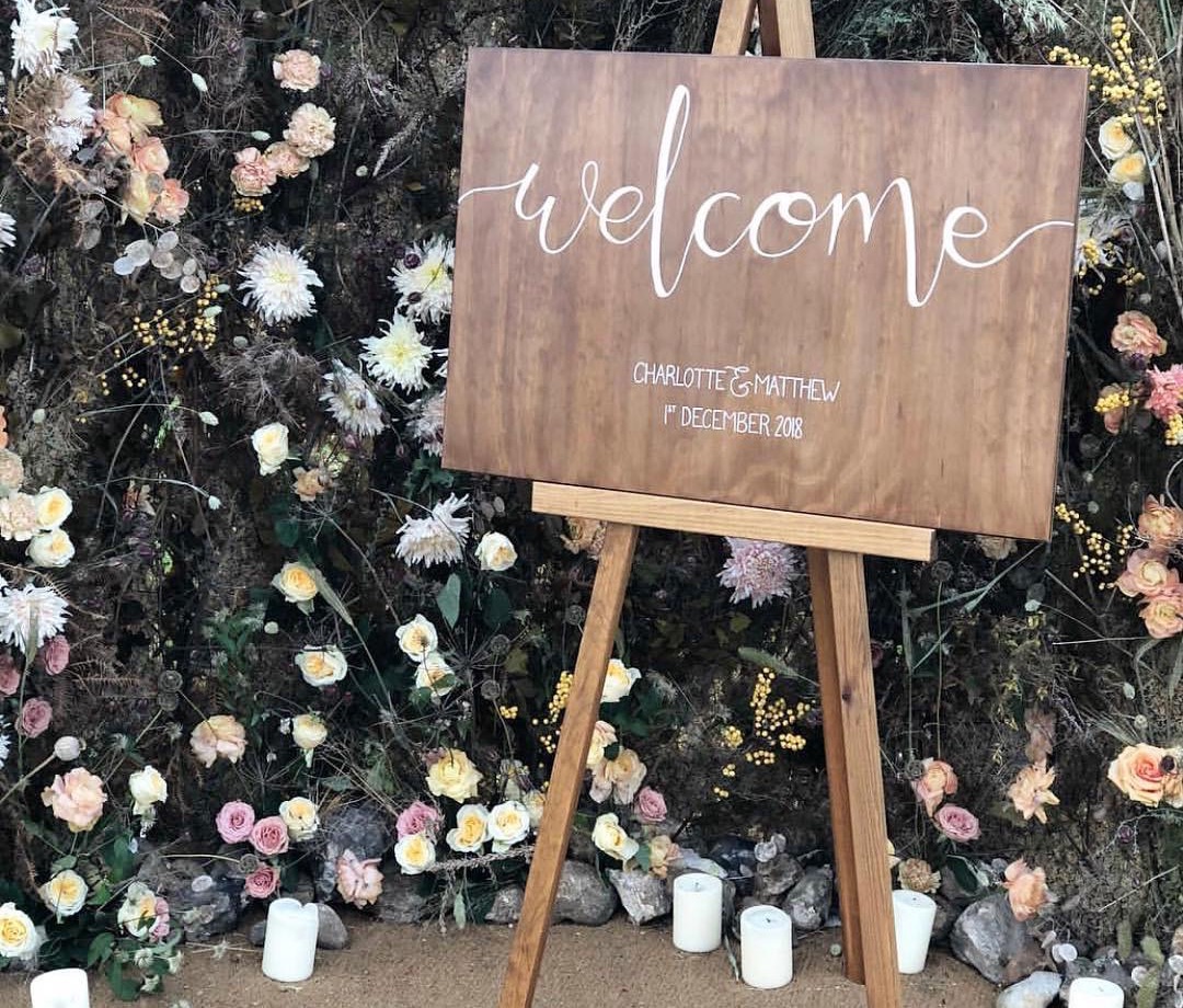 wooden welcome sign with modern calligraphy hand written detail