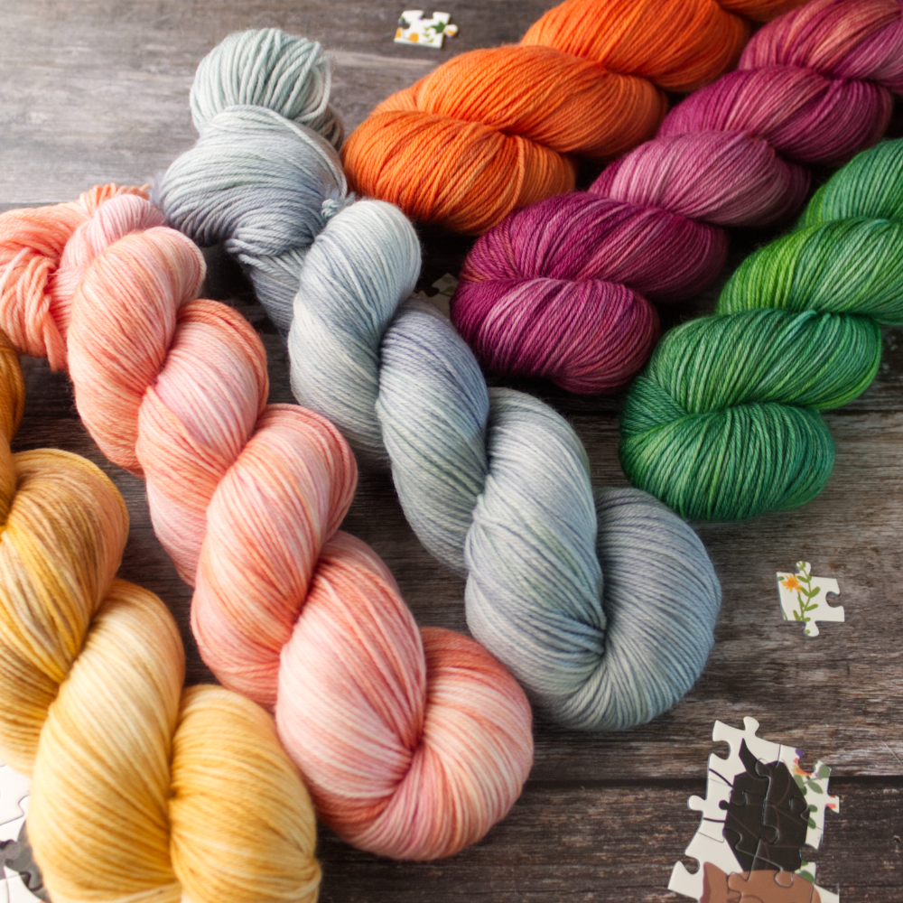 6 colourful semi solids skeins from the rea dragon collection, gold, pink, blue, orange, purple, green