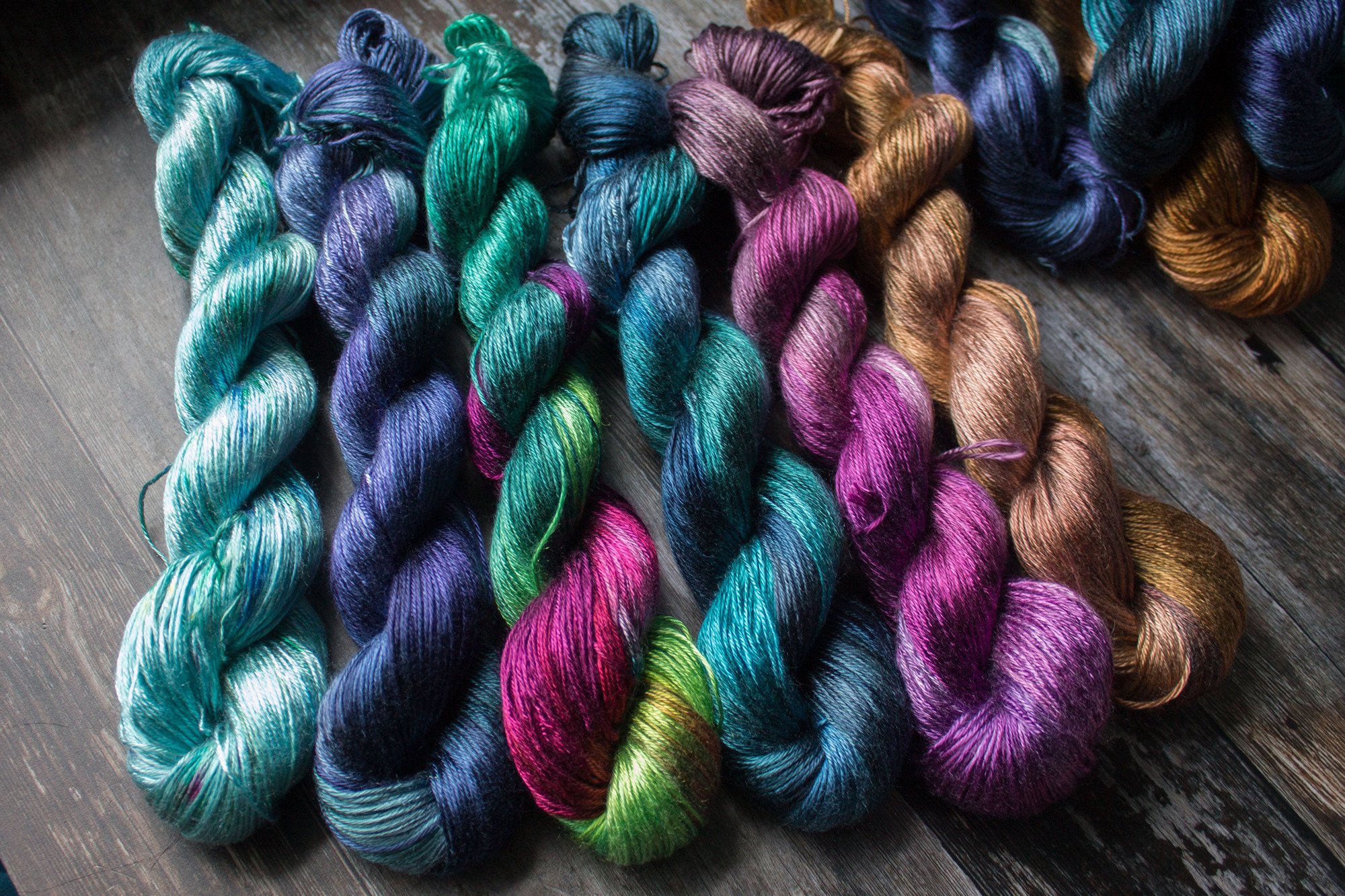 a selection of shiny yarns on tencel ranging from blue to bronze