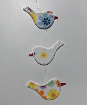 Trio of white opaque glass hanging Birds with multi floral design 