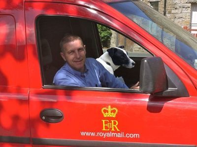 Postman in his van with dog