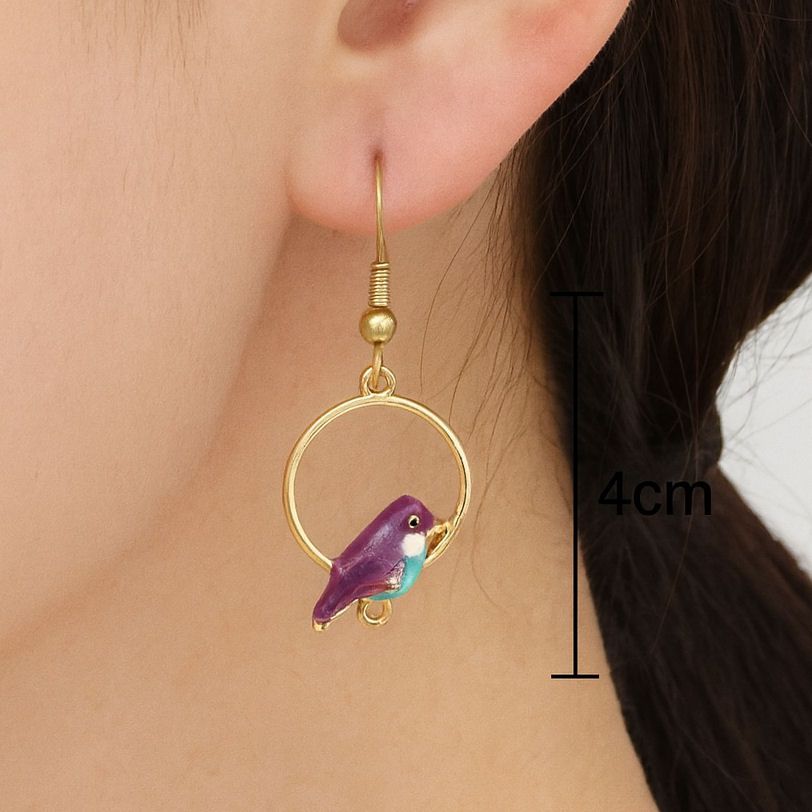 Close-up of a woman's ear wearing a 4cm-long gold hoop earring with a vibra