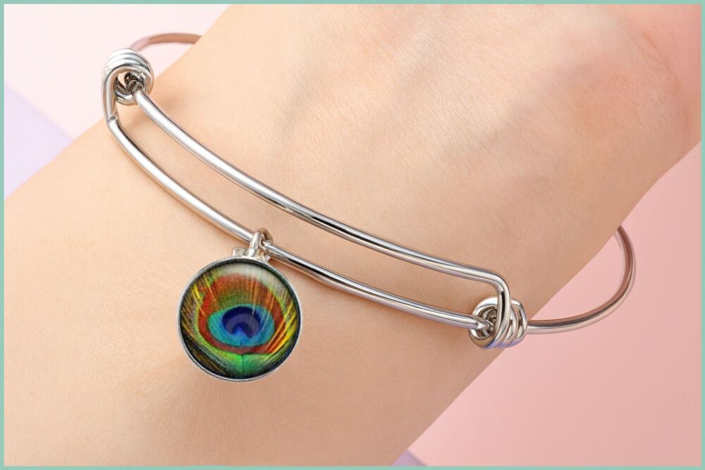 Elegant Silver Bangle with Peacock Eye Feather Glass Dome Accent
