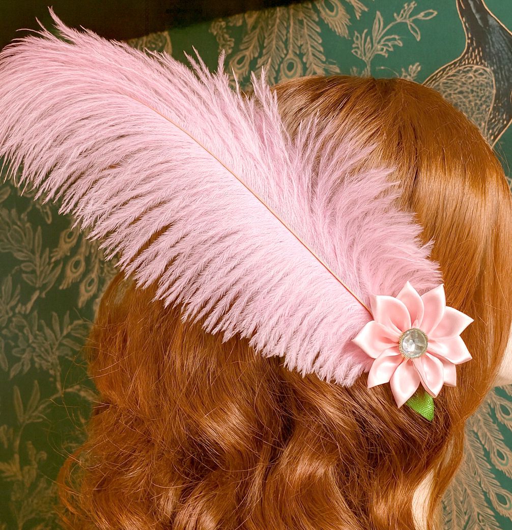 Auburn curly hair with a large pink feather and satin flower hair clip, set