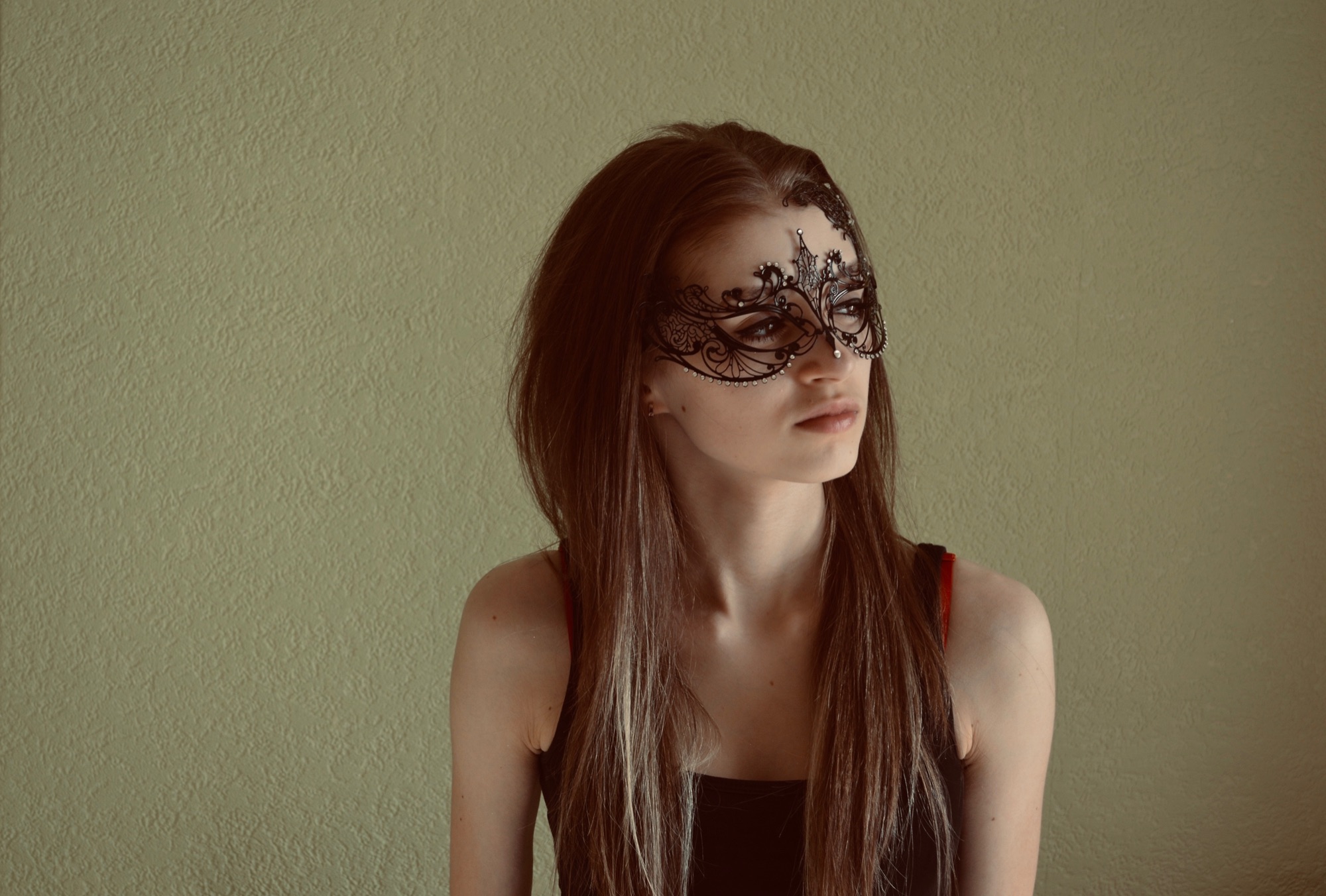girl wearing a masked ball mask for her school project