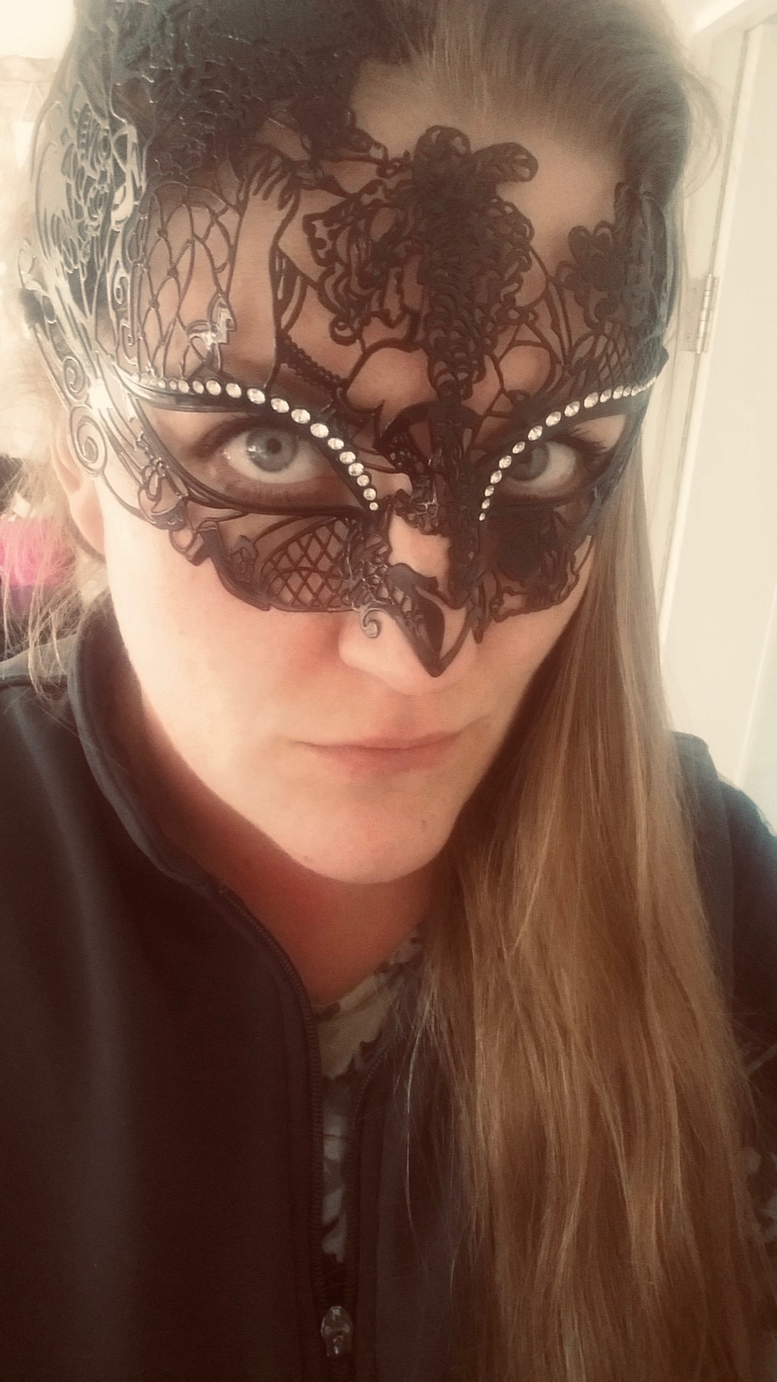 Customer at masquerade ball wearing black Venetian filigree mask by Simply Masquerade