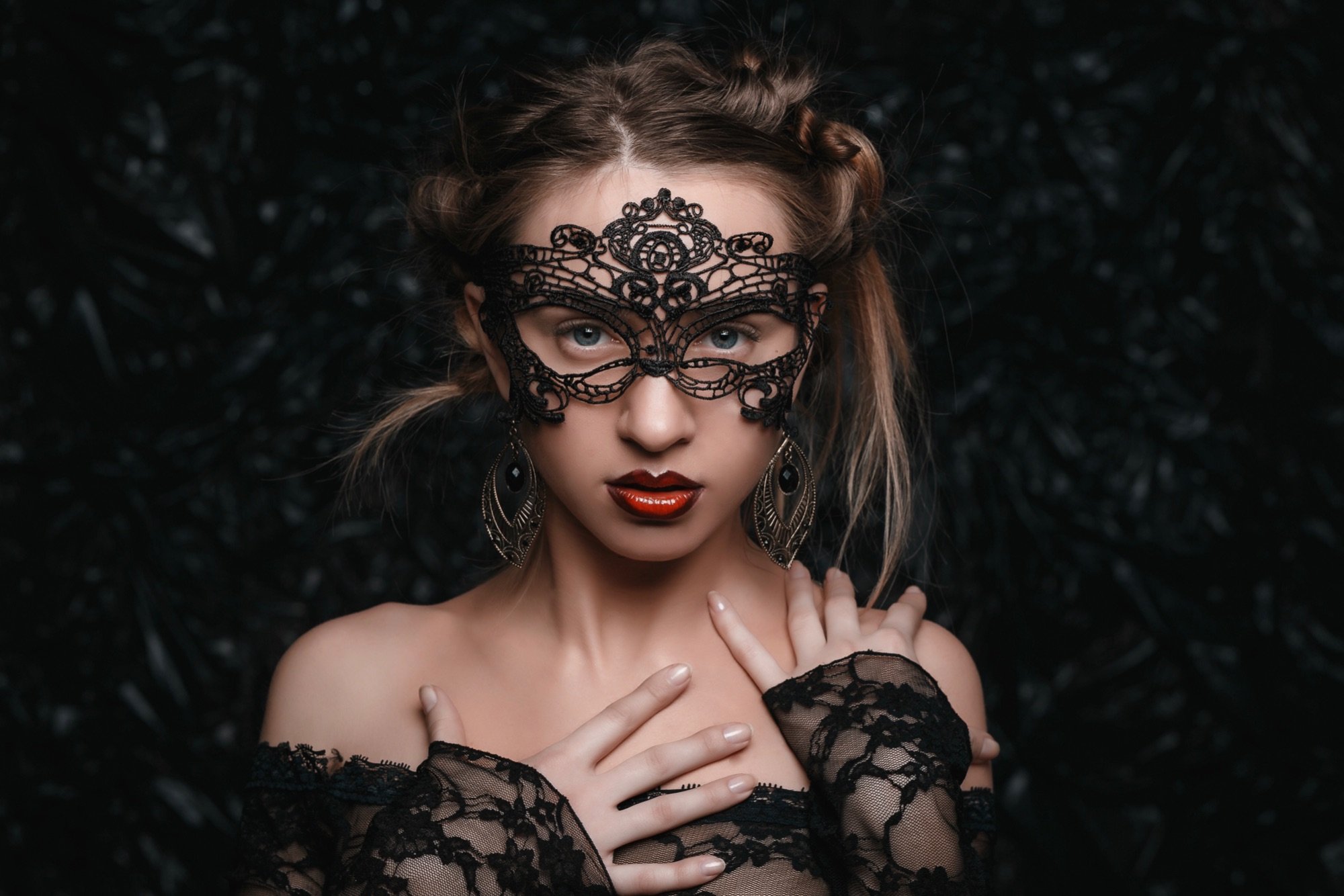 black lace masquerade mask worn  by a pretty blonde woman
