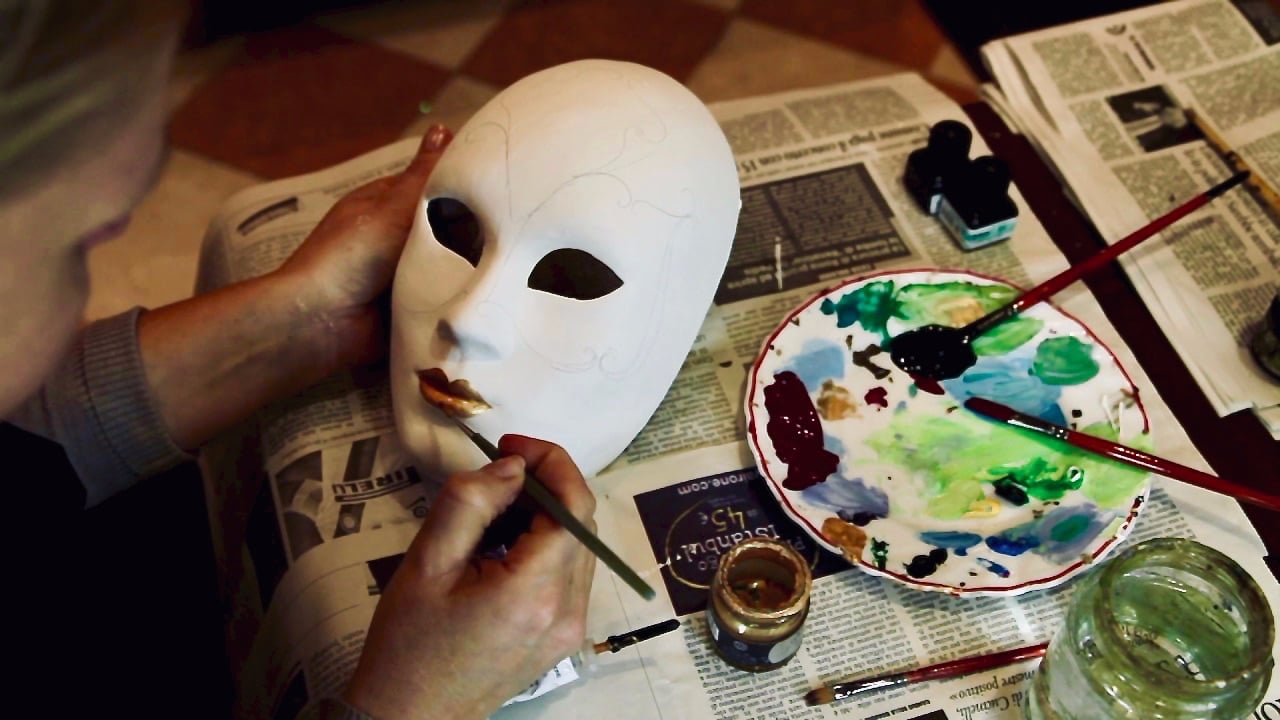  blank Full face masquerade mask being decorated and painted