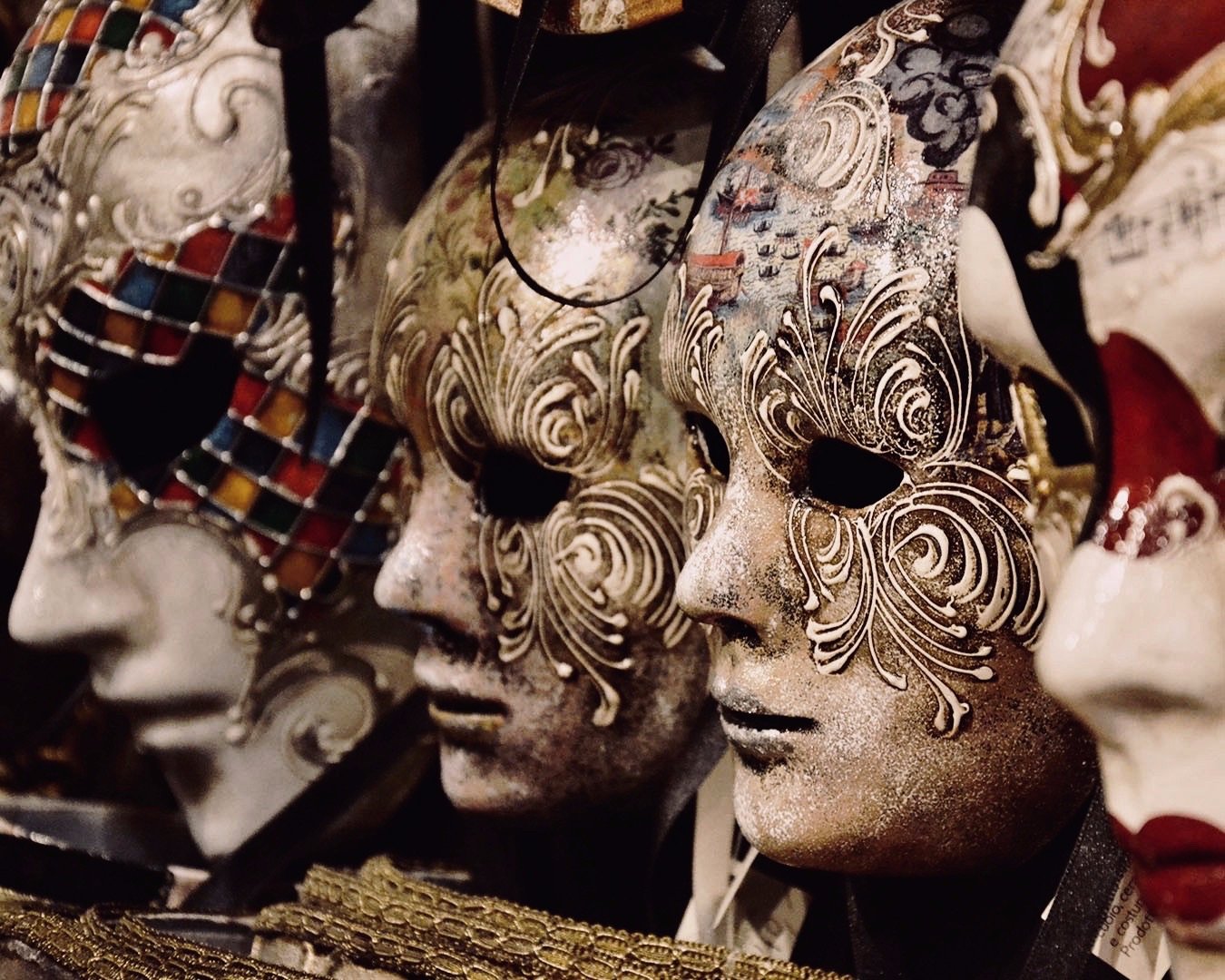 stunning venetian masks on a wall of a shop in Venice, Italy