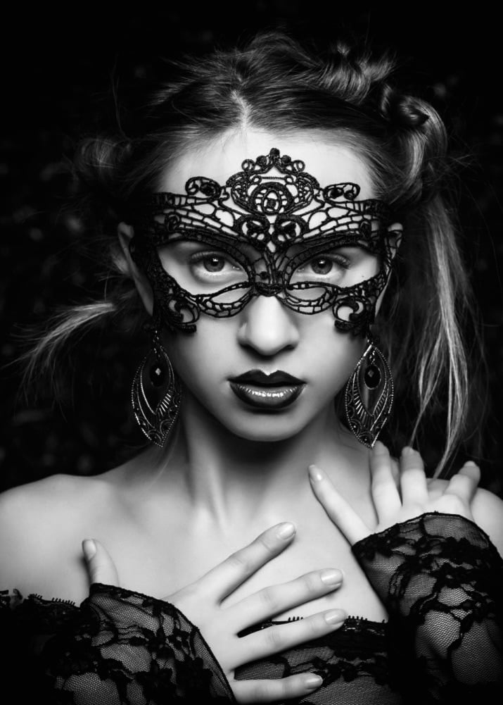 Black lace masquerade mask worn by blonde haired girl