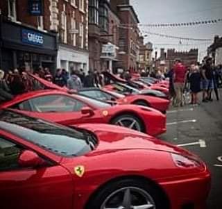 A line of red italian supercars in Bridgnorth High street for the moto