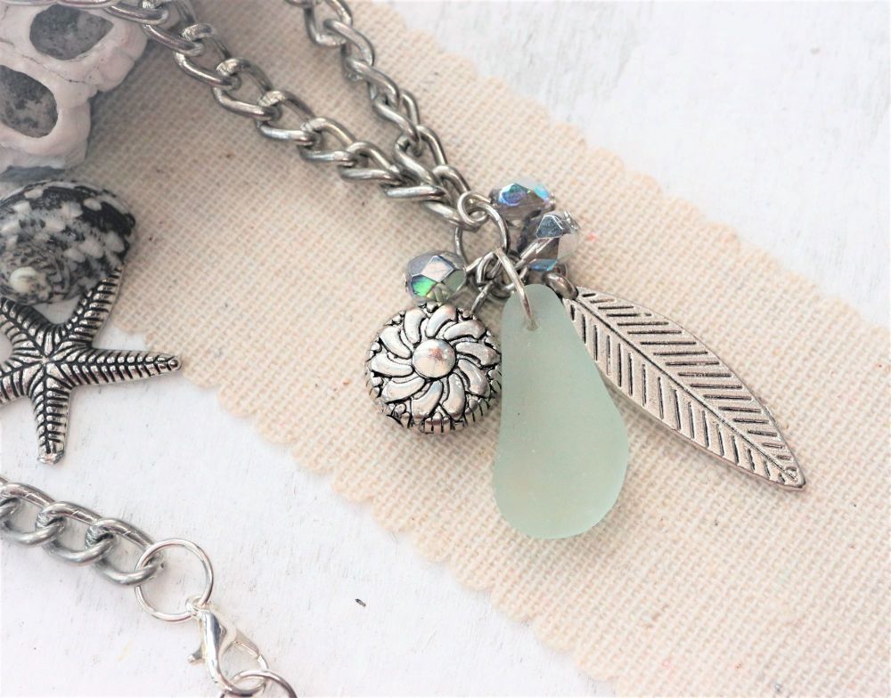 Sea glass beads and a leaf