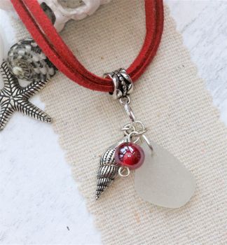 White sea glass with red and a shell
