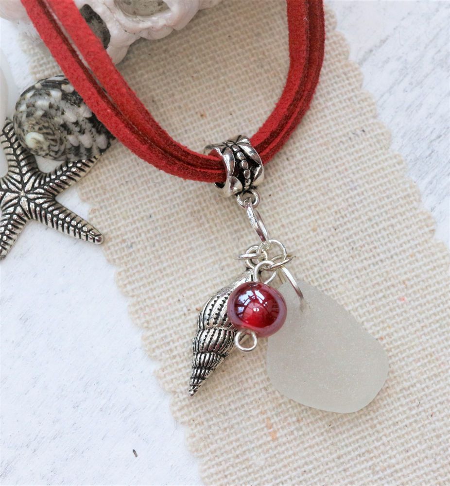 White sea glass with red and a shell