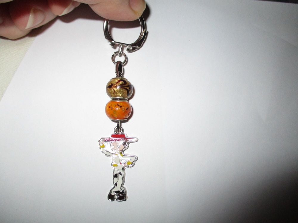 Caramel Orange Glass Bead and Jess The Cowgirl Themed Metal Charm Keyring