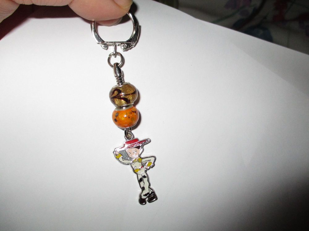Caramel Orange Glass Bead and Jess The Cowgirl Themed Metal Charm Keyring