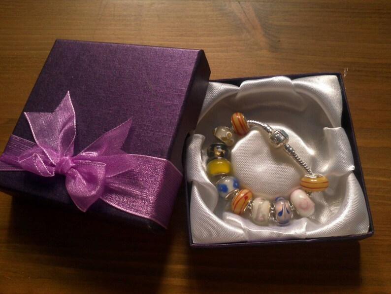 Stunning Eastern Florals Summer charm bracelet. Snake Chain with snap closure. Gift boxed.