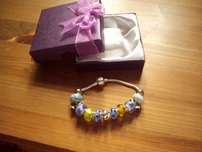 Stunning Seaside Summer Dolphin and Seahorses charm bracelet. Snake Chain with snap closure. Gift boxed.