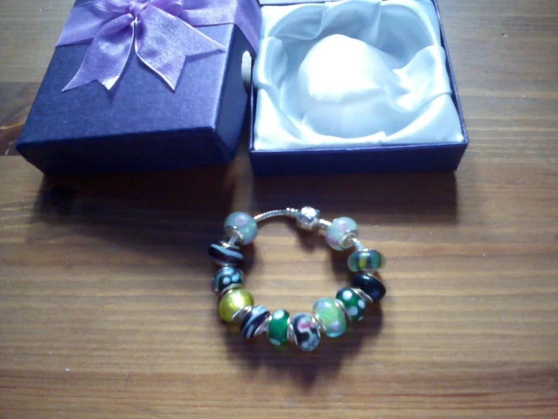 Stunning floral summer hedgerow charm bracelet. Snake Chain with snap closure. Gift boxed.